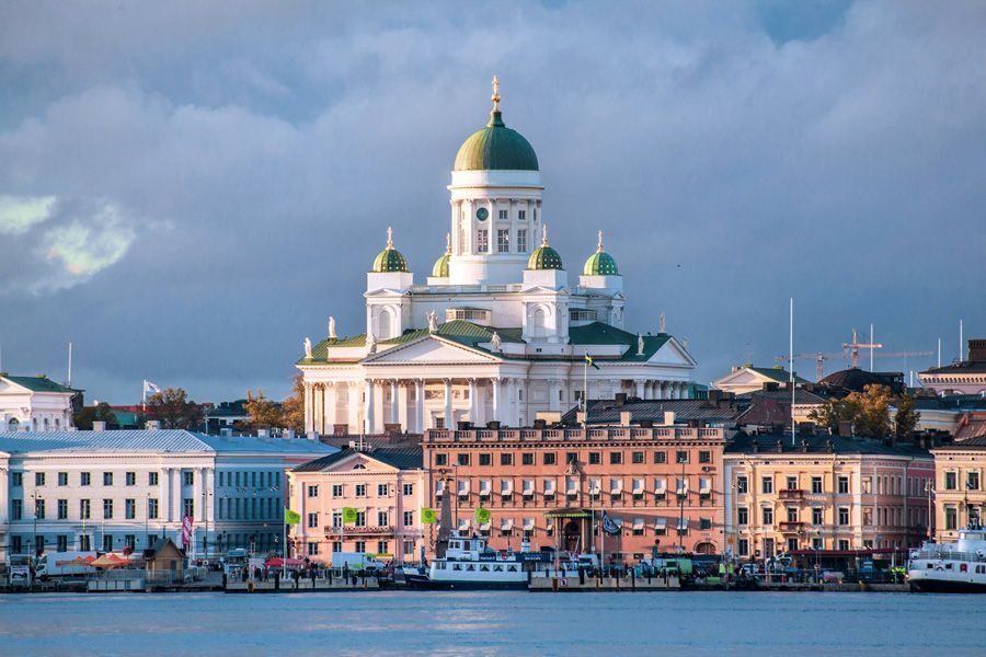 Helsinki Cathedral rising above colourful harbourfront buildings