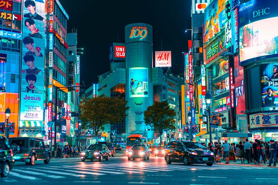 Night traffic and neon signs at Shibuya Crossing in Tokyo